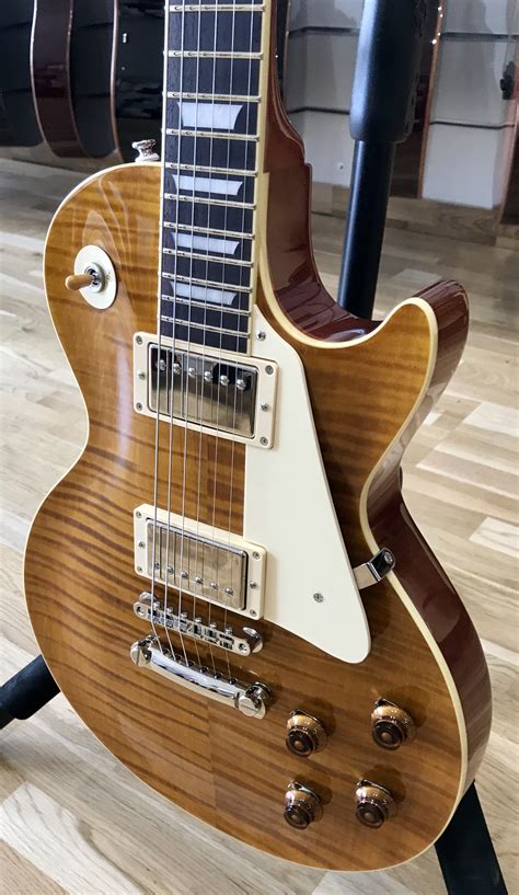This one has the "lawsuit" headstock, one-piece mahogany neck, one-piece rosewood fingerboard, solid maple top, deep top carve, solid mahogany back (w/ no Swiss cheese holes or chambers), full-size pots, and it is in excellent shape minus the dings around the input jack (pictured). . Tokai love rock